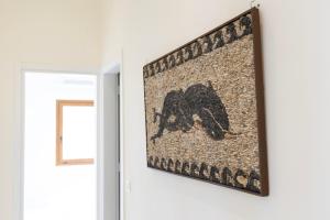 a painting hanging on a wall next to a door at the shelter - a milos project in Adamantas