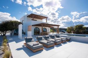 a patio with couches and a swimming pool at the shelter - a milos project in Adamantas +30 photos