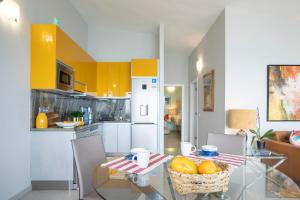 a kitchen with a table with a basket of fruit on it at In Tenerife, luxury apartment overlooking the Atlantic in Bajamar