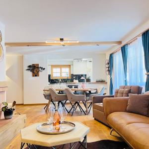 a living room with a couch and a table at Chalet Mountain Lodge in Kandersteg