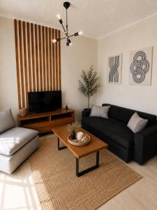 a living room with a couch and a coffee table at Euphoria Suites and Studios in Sidari