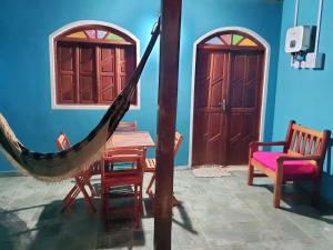 a room with a hammock and a table and a door at Nosso Cantinho no interior in Lençóis