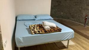 a bed with a leopard blanket and a towel on it at Natura Koman in Koman
