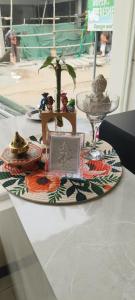 a table with a plate of food and a wine glass at Hotel KGR in Palni
