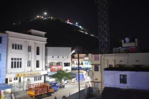 a view of a city at night with a street at Hotel KGR in Palni