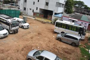 a group of cars parked in a dirt parking lot at Hotel KGR in Palni +13 photos