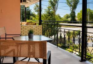 a patio with a table and chairs on a balcony at Euphoria Suites and Studios in Sidari