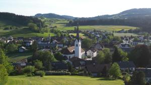 an aerial view of a small village with a church at Richters Alpen Appartement in Buchenberg