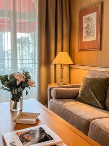 a living room with a couch and a table at Carlton Lausanne Boutique Hôtel in Lausanne