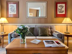 a living room with a couch and a table at Carlton Lausanne Boutique Hôtel in Lausanne