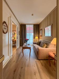 a living room with a couch and a table at Carlton Lausanne Boutique Hôtel in Lausanne