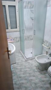 a bathroom with a shower and a toilet and a sink at Villa Aurora in Ispica +13 photos