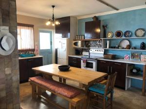 a kitchen with a wooden table and a dining room at Oceanview Sunrise Beach Villa in Rocklands