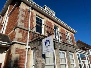 a sign on the side of a brick building at Swan Lodge in Swanage