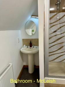a bathroom with a sink and a mirror at Feochan Portree in Portree +68 photos