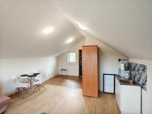 a kitchen and living room with a table and chairs at Apartament Bliżej Nieba in Bącza
