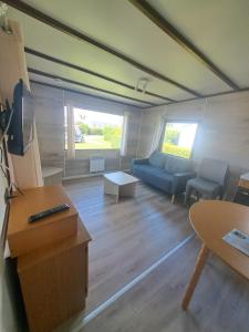 a living room with a couch and a table at Camping Les 2 Plages in Quend