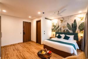a hotel room with a bed and a couch at Hibiscus Elite Hotel in Greater Noida +39 photos