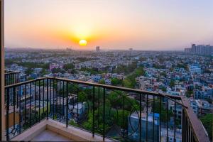 a view of a city at sunset from a building at Hibiscus Elite Hotel in Greater Noida