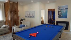 a living room with a pool table in it at Paradisus III in São Martinho do Porto