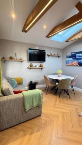 a living room with a couch and a table at Little Cottage Oassis in Dublin