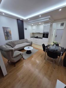 a living room with a couch and a table at Apartman Jezdić in Banja Koviljača