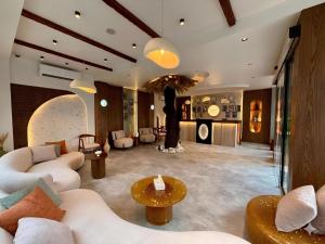a living room with couches and a tree in the middle at Pyramids Spiritual Hotel in Cairo