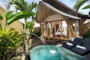 a swimming pool in front of a villa at The Scape Valley Villas in Tampaksiring
