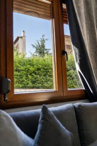 a window in a room with a couch looking out at Bright and central apartment in Siátista