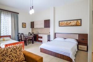 a hotel room with two beds and a kitchen at Hotel Alba in Shëngjin