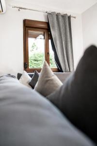 a bedroom with a bed and a window at Bright and central apartment in Siátista +27 photos