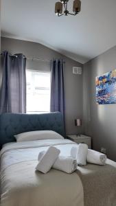 a bedroom with a bed with two pillows on it at Little Cottage Oassis in Dublin