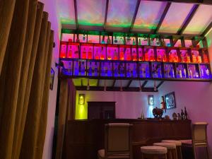 a bar with a bunch of bottles on a shelf at Farm House Villa in Ratnapura +23 photos