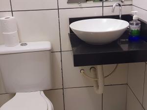 a bathroom with a sink on a counter next to a toilet at Nosso Cantinho no interior in Lençóis +11 photos