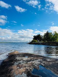 a view of a body of water with a blue sky at Tiny house with lake view in Hammarö +8 photos