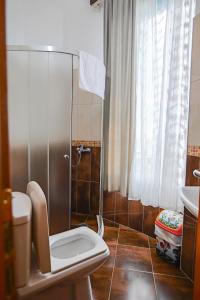 a bathroom with a shower with a toilet and a sink at Hotel Alba in Shëngjin +79 photos