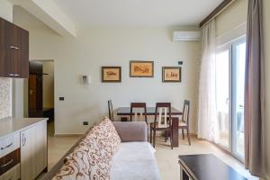 a living room with a couch and a table at Hotel Alba in Shëngjin