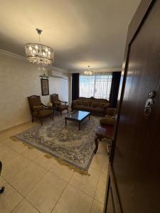 a living room with a couch and a table at Toum's Apartments in Amman
