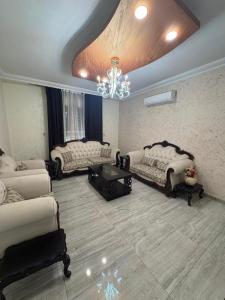 a large living room with couches and a chandelier at Toum's Apartments in Amman +44 photos