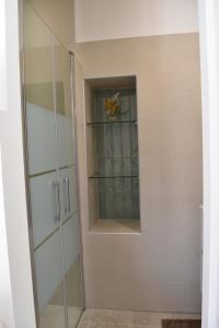 a walk in shower with a glass door at A Casetta d'Armonio in Piana +22 photos