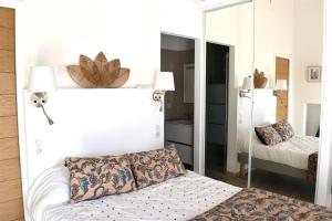 a bedroom with a mirror and a bed at A Casetta d'Armonio in Piana