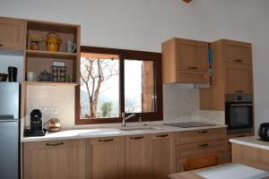 a kitchen with wooden cabinets and a window at A Casetta d'Armonio in Piana
