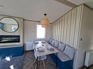 a small living room with a table and a couch at Three Lochs Holiday Park, 139 Loch View with Lazy Spa Hot Tub, Platinum 3 bedroom Holiday Home for Hire in Balminnoch