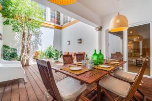 a dining room with a wooden table and chairs at CICAS VILLA in Albufeira