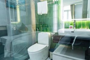 a bathroom with a white toilet and a sink at HoangAnh Hotel in Ha Long +12 photos