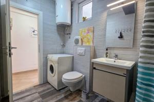 a bathroom with a toilet and a sink at Apartman Darija 3 in Gornji Orahovac +43 photos