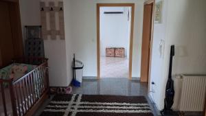 a hallway with a crib and a door to a room at Apartman Ružica in Tomislavgrad