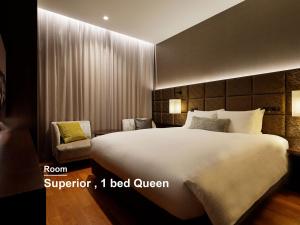 a bedroom with a large bed and a chair at Mitsui Garden Hotel Osaka PREMIER in Osaka