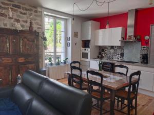 a kitchen and dining room with a table and chairs at Chambrecosy maison de charme proche gare et centre historique in Quimper