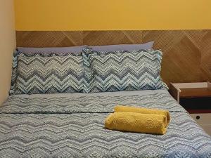 a bed with a yellow blanket on top of it at Nosso Cantinho no interior in Lençóis